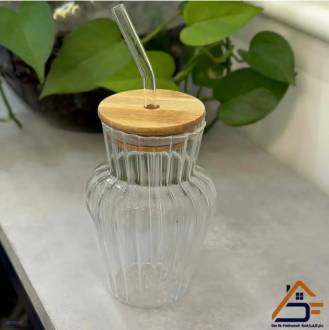 كوب زجاجي بغطاء خشبي ومصاصة